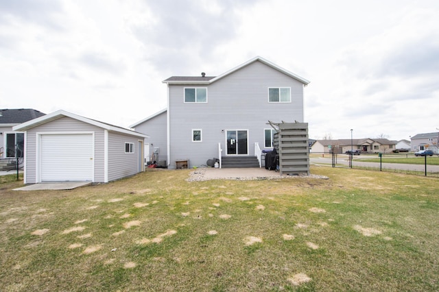 rear view of property featuring fence, an outdoor structure, a yard, and a patio area