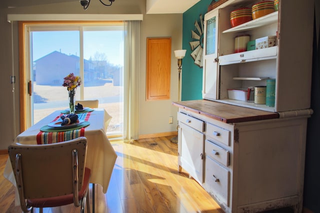 dining room with baseboards and light wood-style floors