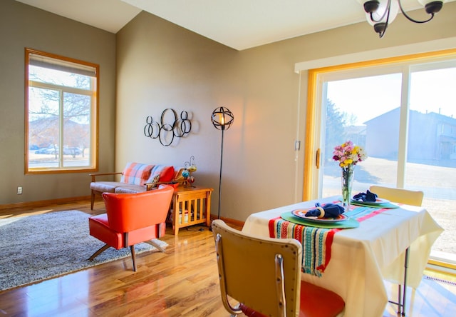 dining room featuring baseboards and light wood finished floors