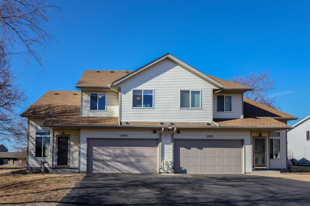 view of front of home featuring aphalt driveway, a shingled roof, and an attached garage