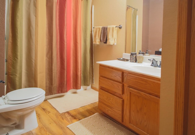 full bathroom with vanity, wood finished floors, toilet, and a shower with curtain