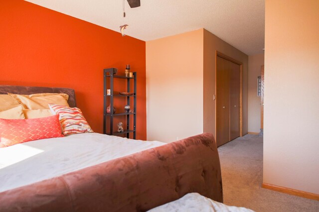 carpeted bedroom featuring a ceiling fan and baseboards