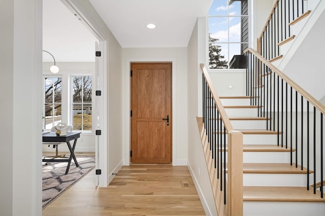 foyer with stairway, recessed lighting, wood finished floors, and baseboards