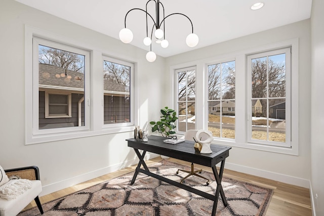 office with a wealth of natural light, baseboards, and an inviting chandelier