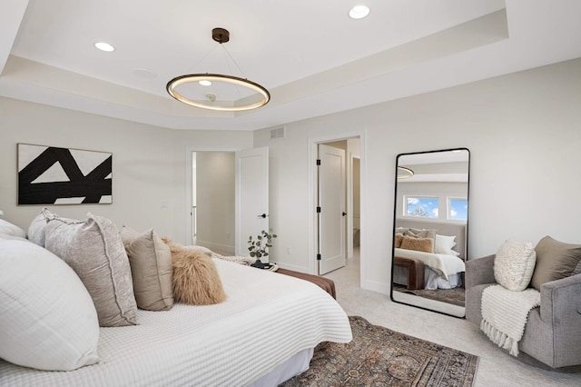 bedroom featuring visible vents, light carpet, a raised ceiling, recessed lighting, and baseboards