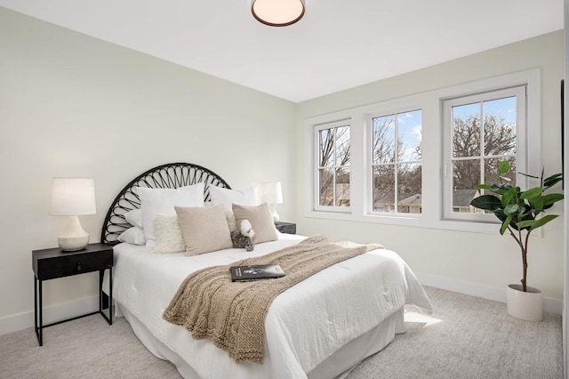 bedroom with baseboards and carpet flooring