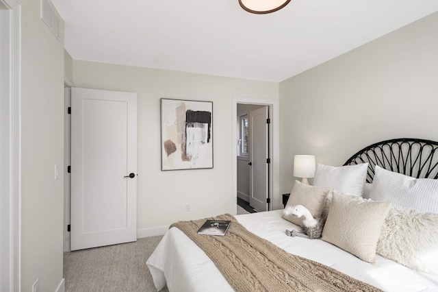 carpeted bedroom featuring visible vents and baseboards