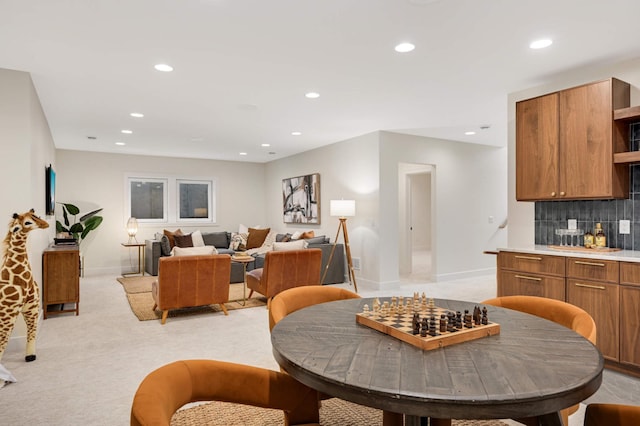 dining space with recessed lighting, baseboards, and light carpet