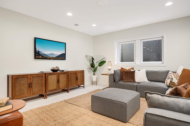 living room featuring recessed lighting, baseboards, and light carpet