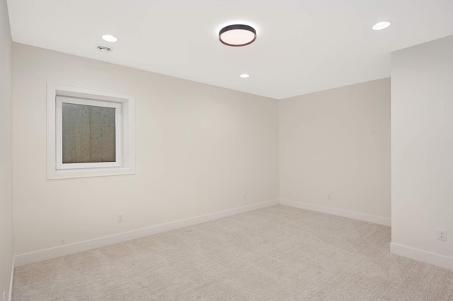 unfurnished room featuring light carpet, recessed lighting, and baseboards