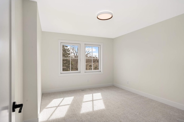 carpeted spare room with baseboards