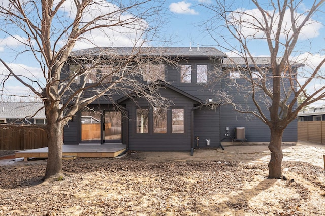 rear view of property with central AC unit, a patio, a deck, and fence