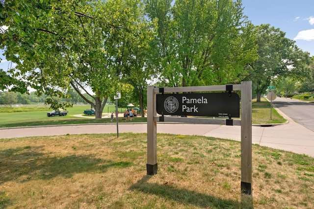 community / neighborhood sign with a yard