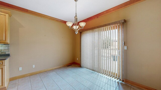 unfurnished dining area with light tile patterned floors, baseboards, a chandelier, and crown molding