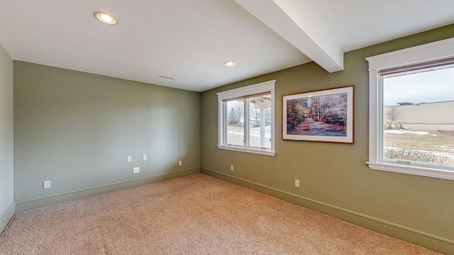 carpeted spare room with recessed lighting, beamed ceiling, and baseboards