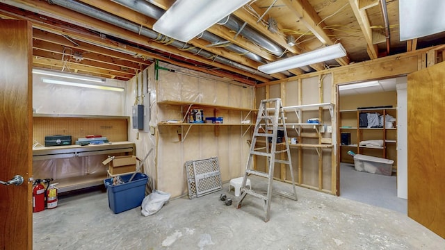 unfinished basement featuring electric panel