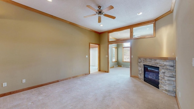 unfurnished living room featuring crown molding, ceiling fan, a fireplace, and light colored carpet
