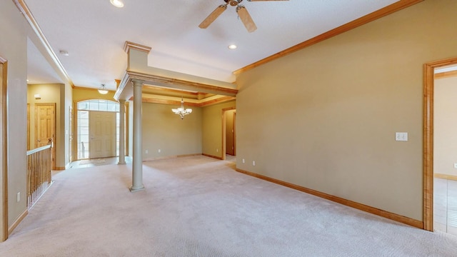 unfurnished living room with crown molding, baseboards, ceiling fan with notable chandelier, and ornate columns