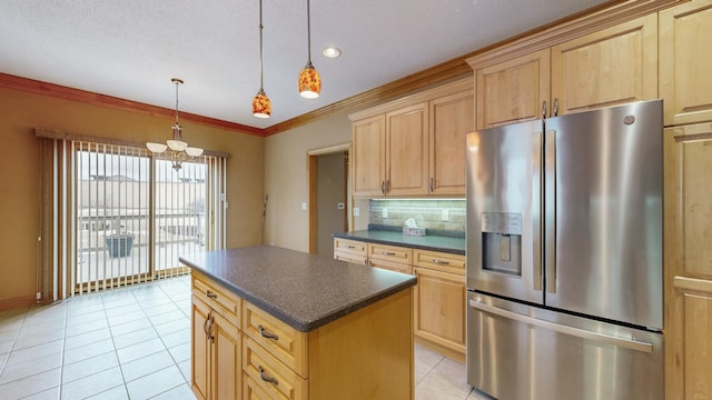 kitchen with light brown cabinetry, dark countertops, stainless steel fridge, a chandelier, and backsplash