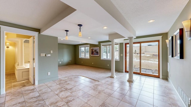 interior space featuring decorative columns, visible vents, baseboards, recessed lighting, and light tile patterned flooring
