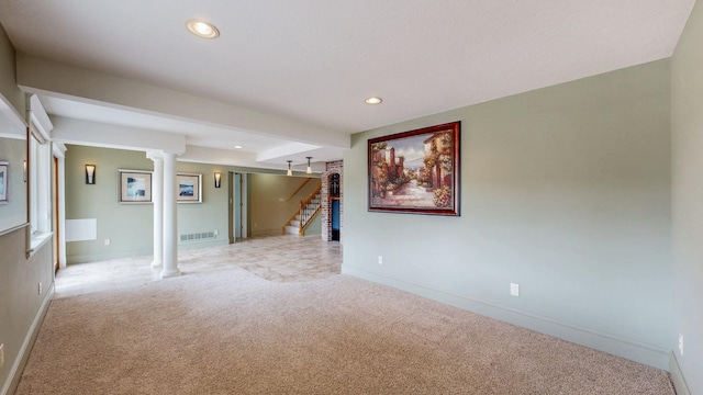 basement featuring stairs, light colored carpet, and visible vents