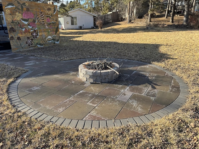 view of yard with an outdoor fire pit, a patio area, and fence