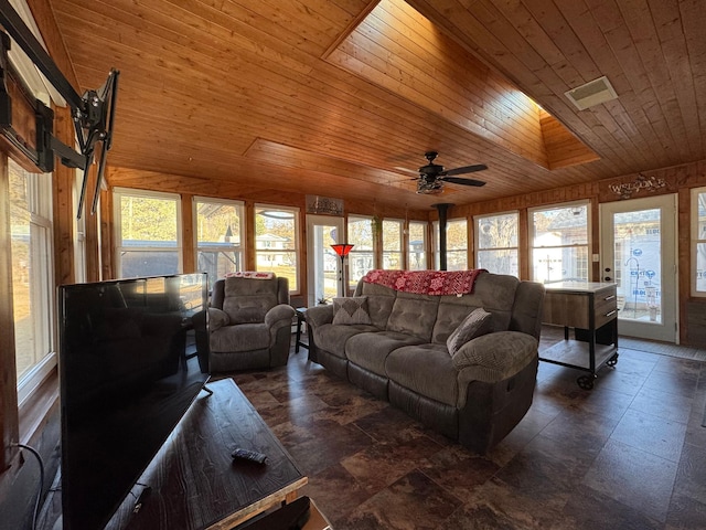 living room featuring ceiling fan and wooden ceiling