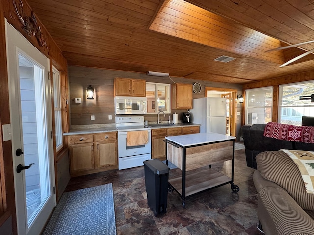 kitchen featuring white appliances, wood ceiling, light countertops, and a sink