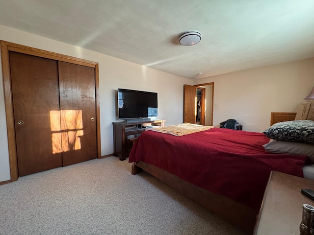 bedroom with light carpet and baseboards