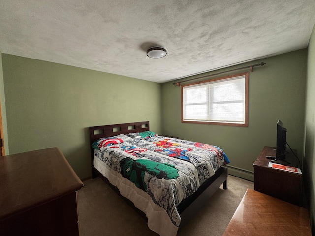 carpeted bedroom featuring a textured ceiling and a baseboard heating unit