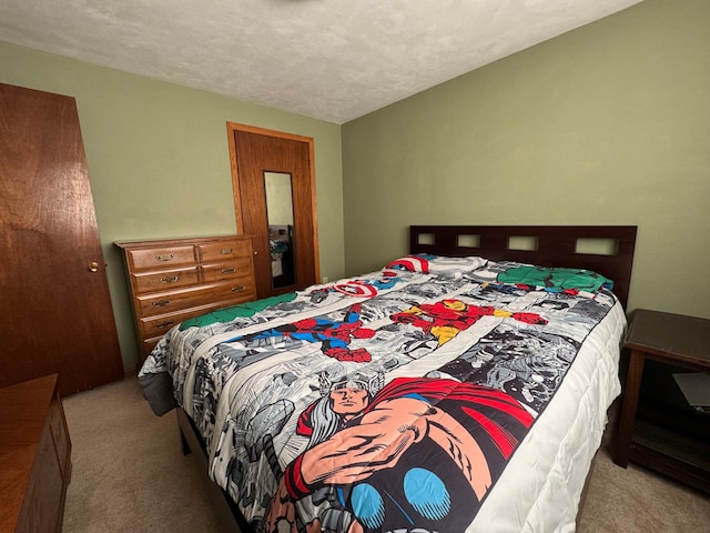 bedroom featuring carpet floors and a textured ceiling