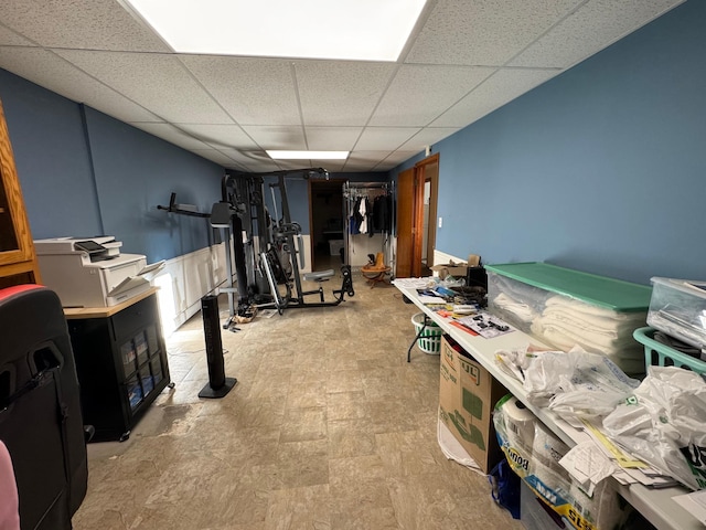 workout room with a paneled ceiling