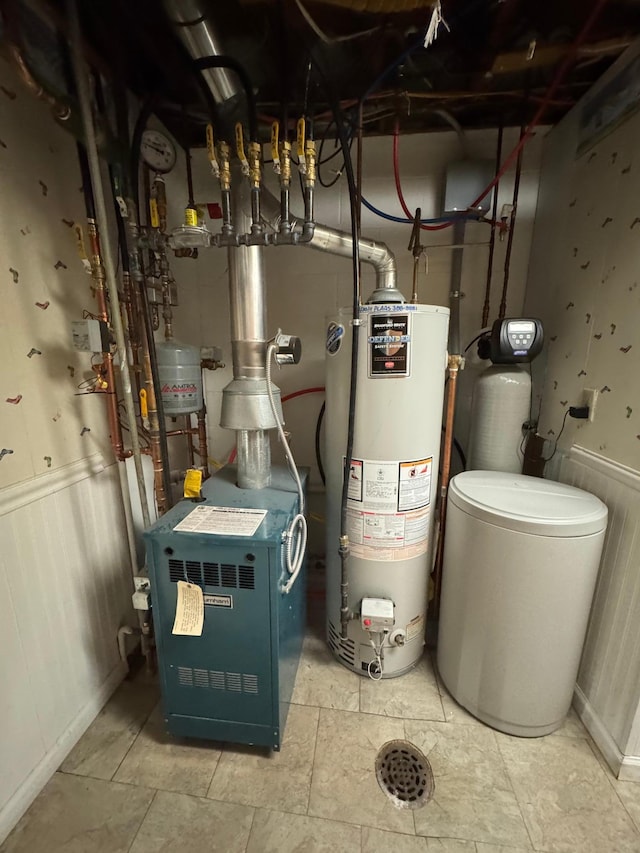 utility room featuring water heater and a heating unit