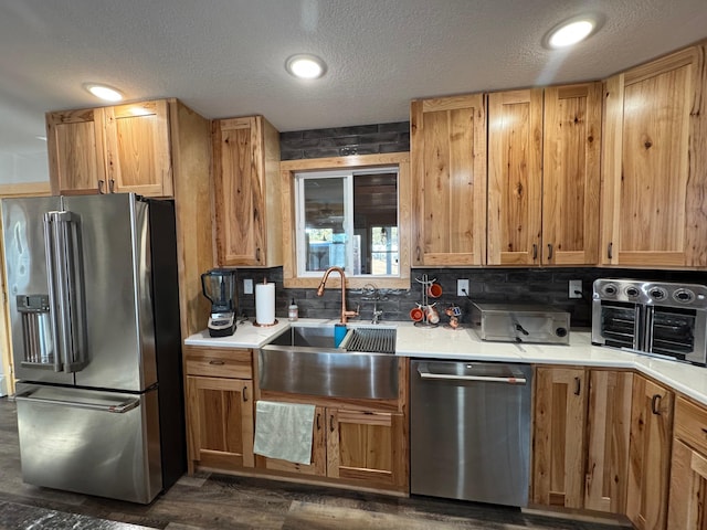 1903 Lenore Ln, Red Wing, MN 55066 - kitchen with stainless steel appliances, a sink, a textured ceiling, light countertops, and tasteful backsplash