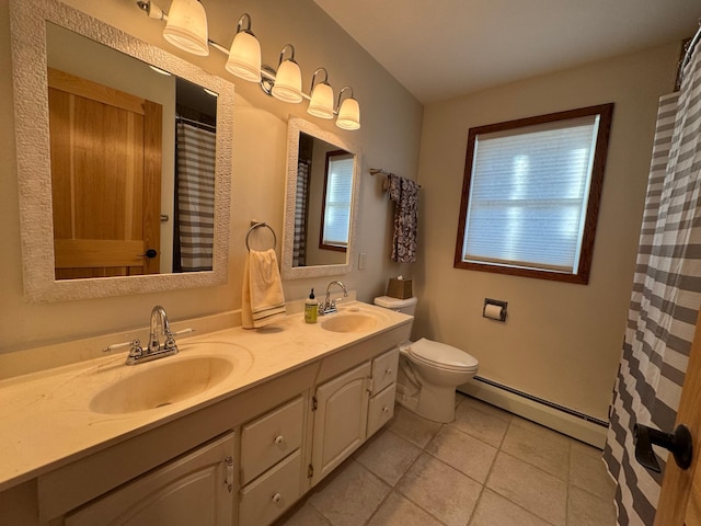 1903 Lenore Ln, Red Wing, MN 55066 - bathroom featuring a baseboard radiator, tile patterned floors, double vanity, toilet, and plenty of natural light