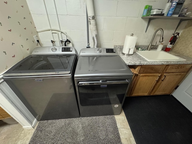 1903 Lenore Ln, Red Wing, MN 55066 - laundry room featuring washing machine and clothes dryer, concrete block wall, and cabinet space
