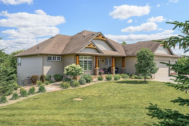 view of front facade with driveway, roof with shingles, an attached garage, cooling unit, and a front lawn