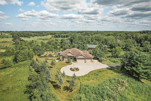 birds eye view of property featuring a wooded view