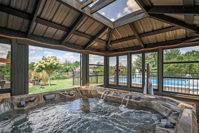 sunroom / solarium featuring a wealth of natural light and a hot tub