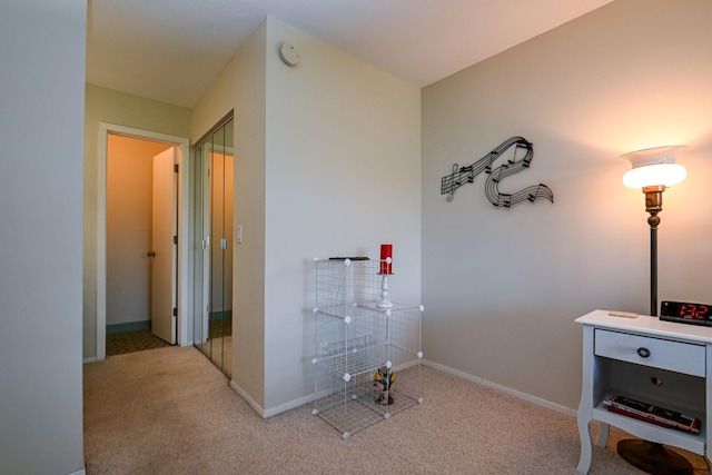 interior space featuring carpet flooring and baseboards