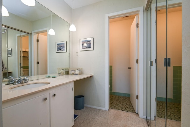 bathroom with vanity and baseboards