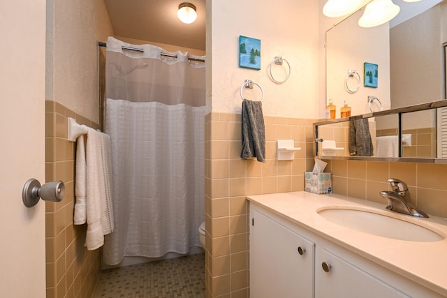 bathroom featuring a wainscoted wall, vanity, tile walls, and a shower with curtain