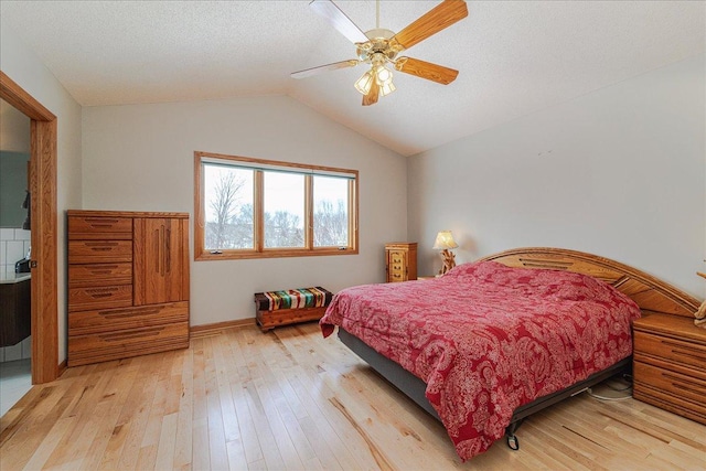 bedroom featuring a textured ceiling, a ceiling fan, baseboards, vaulted ceiling, and light wood finished floors