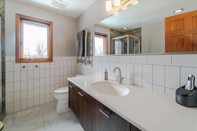 bathroom with a stall shower, marble finish floor, visible vents, and vanity