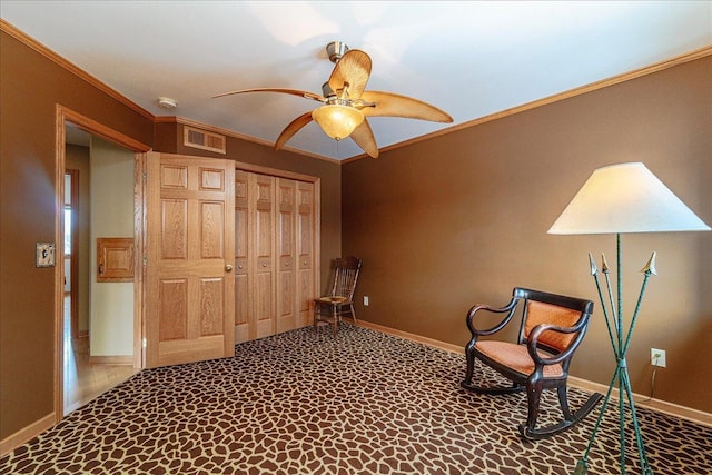 unfurnished room with carpet floors, visible vents, ornamental molding, ceiling fan, and baseboards