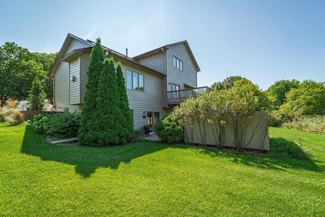 back of house with a lawn