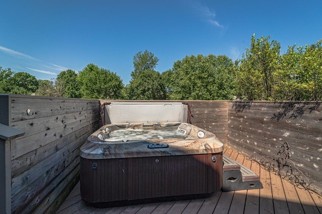 wooden deck with a hot tub