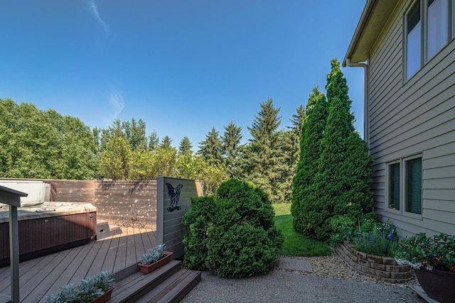 view of yard with a deck and a hot tub