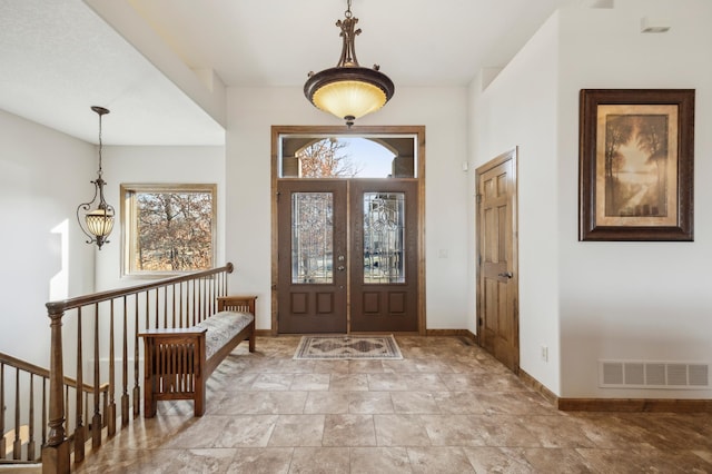 entryway featuring baseboards, visible vents, and french doors