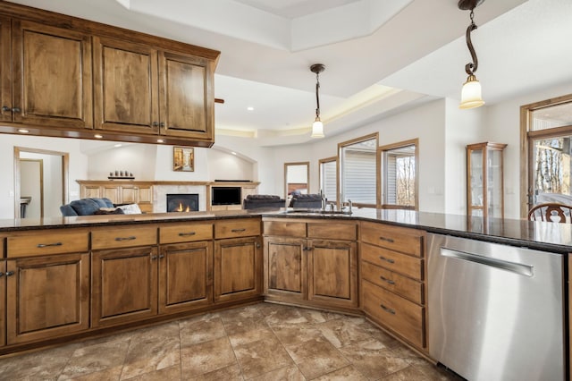 kitchen with brown cabinetry, pendant lighting, dishwasher, and open floor plan